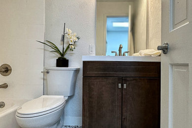 Example of a small minimalist 3/4 white tile cement tile floor, multicolored floor and single-sink bathroom design in Denver with shaker cabinets, dark wood cabinets, a two-piece toilet, white walls, an undermount sink, quartz countertops, white countertops and a freestanding vanity