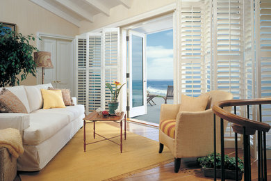 Example of a mid-sized beach style open concept light wood floor living room design in San Francisco with white walls, no fireplace and no tv