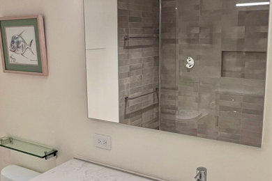 Walk-in shower - mid-sized modern master laminate floor, beige floor and single-sink walk-in shower idea in Charlotte with furniture-like cabinets, brown cabinets, a two-piece toilet, beige walls, an undermount sink, granite countertops, a hinged shower door, white countertops and a floating vanity