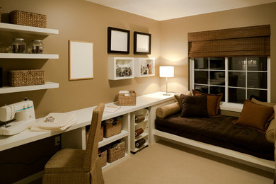 Example of a transitional built-in desk carpeted craft room design in Nashville with brown walls