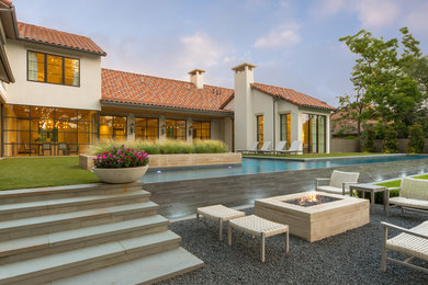 Example of a huge tuscan backyard gravel and custom-shaped infinity pool design in Dallas