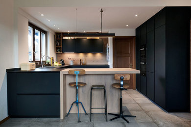 Large contemporary u-shaped open plan kitchen in Other with a double-bowl sink, flat-panel cabinets, black cabinets, timber splashback, black appliances, ceramic floors, with island, grey floor and black benchtop.