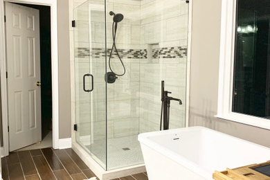 Inspiration for a mid-sized modern master beige tile and porcelain tile porcelain tile and brown floor bathroom remodel in Atlanta with recessed-panel cabinets, a two-piece toilet, brown walls and a hinged shower door
