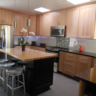 Mid-sized contemporary kitchen pantry photos - Kitchen pantry - mid-sized contemporary u-shaped slate floor kitchen pantry idea in Albuquerque with flat-panel cabinets, light wood cabinets, wood countertops, white backsplash, ceramic backsplash, stainless steel appliances and an island
