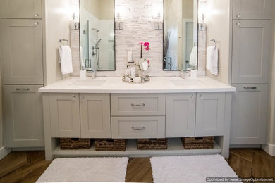 Bathroom - large transitional master white tile and stone tile light wood floor bathroom idea in Phoenix with shaker cabinets, white cabinets, white walls, an undermount sink and solid surface countertops