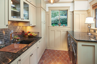 This is an example of a small arts and crafts galley utility room in Cleveland with a single-bowl sink, recessed-panel cabinets, granite benchtops, a side-by-side washer and dryer, beige cabinets, white walls, terra-cotta floors and orange floor.