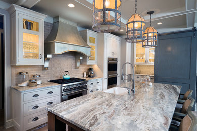 Eat-in kitchen - large transitional u-shaped dark wood floor and brown floor eat-in kitchen idea in Grand Rapids with a farmhouse sink, shaker cabinets, white cabinets, beige backsplash, subway tile backsplash, stainless steel appliances, an island, quartz countertops and gray countertops