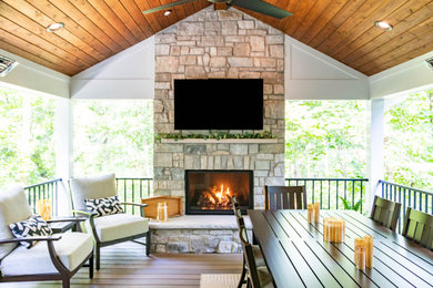 Huge backyard second story metal railing deck photo in St Louis with a fireplace and a roof extension