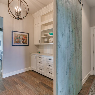 Mid-sized farmhouse kitchen pantry inspiration - Kitchen pantry - mid-sized cottage galley light wood floor and gray floor kitchen pantry idea in Oklahoma City with shaker cabinets, white cabinets, quartz countertops, white backsplash, wood backsplash and no island