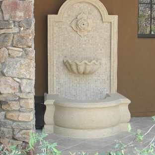 This is an example of a mid-sized traditional backyard garden in Phoenix with a water feature.