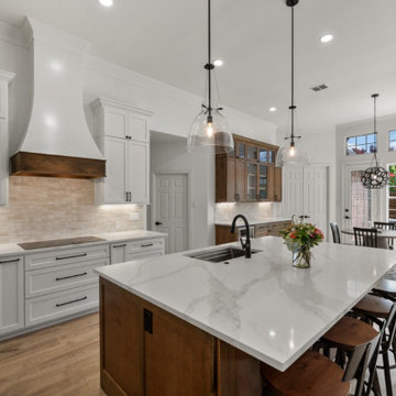 Elegant Kitchen Remodel with White Cabinets and Waterfall Quartz Island