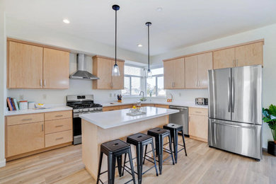 Mid-sized minimalist l-shaped laminate floor, brown floor and exposed beam eat-in kitchen photo in Other with an integrated sink, flat-panel cabinets, light wood cabinets, solid surface countertops, white backsplash, an island and white countertops