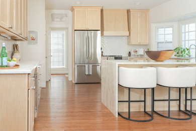 Example of a huge transitional u-shaped open concept kitchen design in DC Metro with recessed-panel cabinets, light wood cabinets, white backsplash, a peninsula and multicolored countertops
