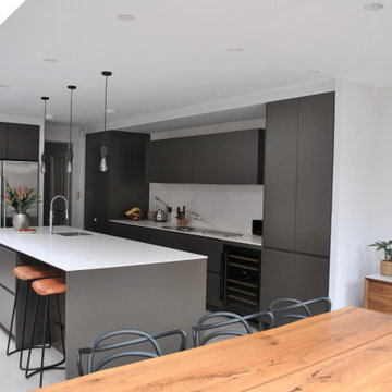 Stylish modern handleless kitchen in dark grey