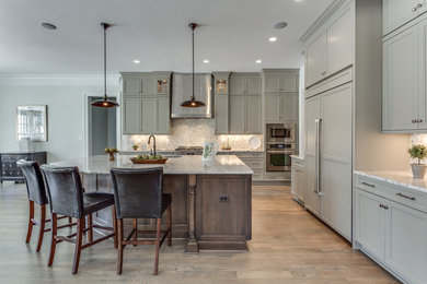 Inspiration for a large transitional kitchen in DC Metro with an undermount sink, shaker cabinets, granite benchtops, stainless steel appliances, medium hardwood floors and with island.