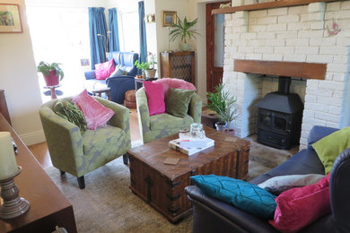 Design ideas for a bohemian living room in Other with a brick fireplace surround.