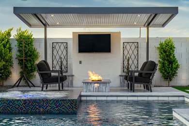 Trendy backyard tile and custom-shaped aboveground pool landscaping photo in Other