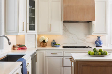Enclosed kitchen - mid-sized transitional u-shaped dark wood floor and brown floor enclosed kitchen idea in Dallas with an undermount sink, raised-panel cabinets, white cabinets, quartz countertops, white backsplash, quartz backsplash, stainless steel appliances, an island and white countertops
