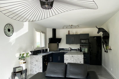 Inspiration for a large contemporary kitchen in Dijon with a submerged sink, laminate countertops, black splashback, mirror splashback, black appliances, concrete flooring, an island, grey floors and grey worktops.
