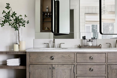 This is an example of a country bathroom in Calgary with shaker cabinets, dark wood cabinets, white walls, a submerged sink, black floors, white worktops, double sinks and a built in vanity unit.