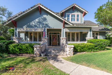Large craftsman green two-story concrete and clapboard exterior home idea in Austin with a tile roof and a gray roof