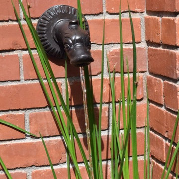Brick Fountain detail of bronze duck scupper