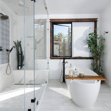 Primary Bathroom remodel featuring a steam shower and a freestanding soaking tub