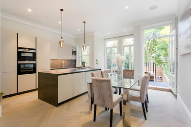 Inspiration for a large contemporary kitchen/dining room in London with medium hardwood flooring.
