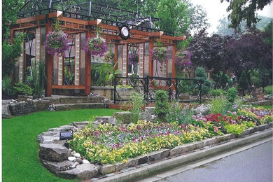 Inspiration for a mid-sized transitional backyard patio remodel in Toronto with a pergola