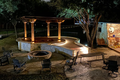 Mid-sized minimalist backyard concrete paver patio photo in Dallas with a fire pit and a pergola
