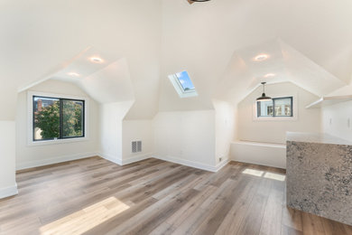 Example of a large arts and crafts master vinyl floor, brown floor and vaulted ceiling bedroom design in Minneapolis with white walls