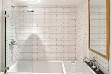 Design ideas for a contemporary bathroom in London with a shower/bathtub combo and subway tile.