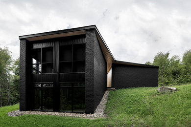 Trendy black exterior home photo in Montreal