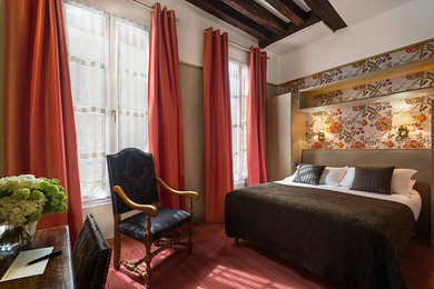 This is an example of a mid-sized traditional bedroom in Paris with multi-coloured walls and carpet.