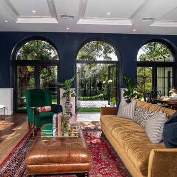 Traditional Living Room with Navy Walls, Arched Doors, and Coffered Ceiling