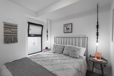Bedroom - scandinavian master dark wood floor and brown floor bedroom idea in Vancouver with white walls