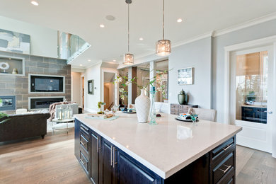 Inspiration for a large modern l-shaped light wood floor and beige floor open concept kitchen remodel in Vancouver with raised-panel cabinets, dark wood cabinets, granite countertops and an island