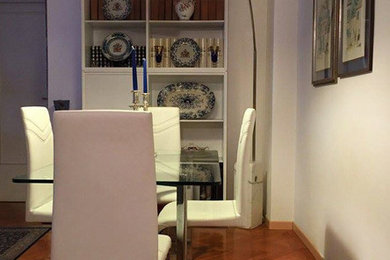 Great room - mid-sized traditional medium tone wood floor great room idea in Other with white walls and no fireplace