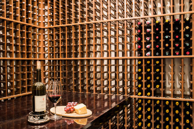 Photo of a mid-sized traditional wine cellar in Other.