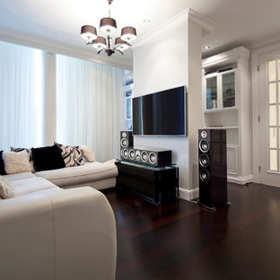 Home theater - mid-sized modern enclosed dark wood floor home theater idea in Oklahoma City with white walls and a wall-mounted tv