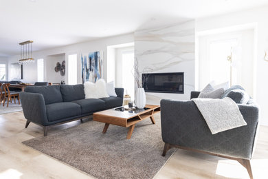Inspiration for a large contemporary open concept vinyl floor and brown floor living room remodel in Vancouver with white walls, a standard fireplace and a tile fireplace