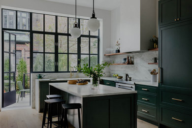 Inspiration for a contemporary l-shaped medium tone wood floor eat-in kitchen remodel in New York with an undermount sink, shaker cabinets, green cabinets, marble countertops, multicolored backsplash, marble backsplash, paneled appliances, an island and multicolored countertops