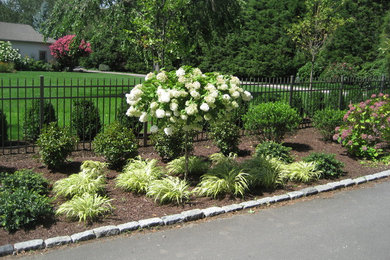 Design ideas for a large traditional backyard full sun driveway in New York with mulch.