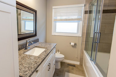 Bathroom - mid-sized transitional master beige tile and porcelain tile travertine floor bathroom idea in San Diego with shaker cabinets, white cabinets, beige walls, an undermount sink and granite countertops