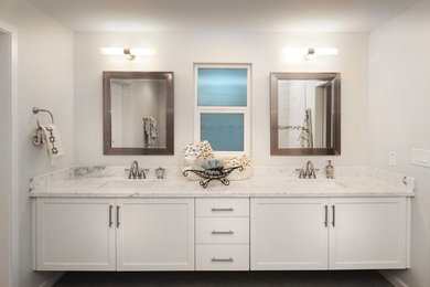 Bathroom - mid-sized transitional master white tile dark wood floor bathroom idea in Phoenix with shaker cabinets, white cabinets, a one-piece toilet, white walls, an undermount sink and marble countertops