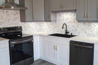 Eat-in kitchen - mid-sized contemporary l-shaped laminate floor and gray floor eat-in kitchen idea in Toronto with a drop-in sink, shaker cabinets, quartzite countertops, white backsplash, porcelain backsplash, stainless steel appliances and white countertops