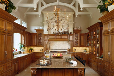 Huge elegant u-shaped porcelain tile eat-in kitchen photo in Chicago with an undermount sink, raised-panel cabinets, medium tone wood cabinets, granite countertops, beige backsplash, stone tile backsplash, paneled appliances and two islands