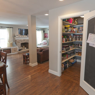 This is an example of a large traditional l-shaped kitchen pantry in Denver with an undermount sink, raised-panel cabinets, white cabinets, granite benchtops, beige splashback, cement tile splashback, stainless steel appliances, medium hardwood floors and with island.