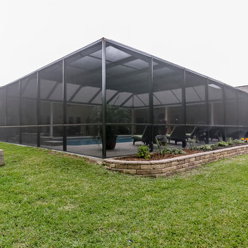 Patio with Fireplace with Screened Pool Enclosure