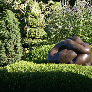 Sculpture tucked into a boxwood hedge